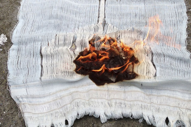 Meredith Brion, video still of textile with fire