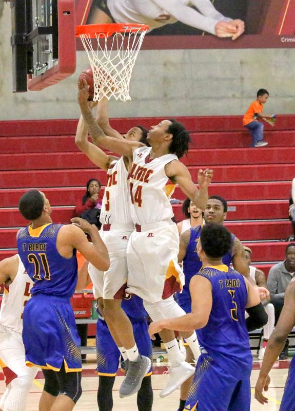 Two players jumping at hoop