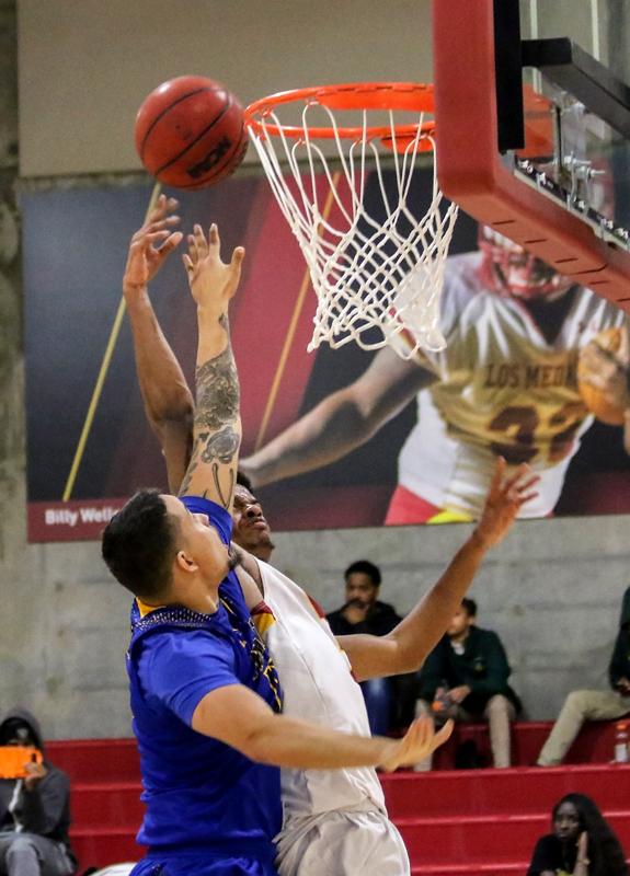 Player pushing ball over rim