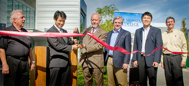 Faculty cutting ribbon